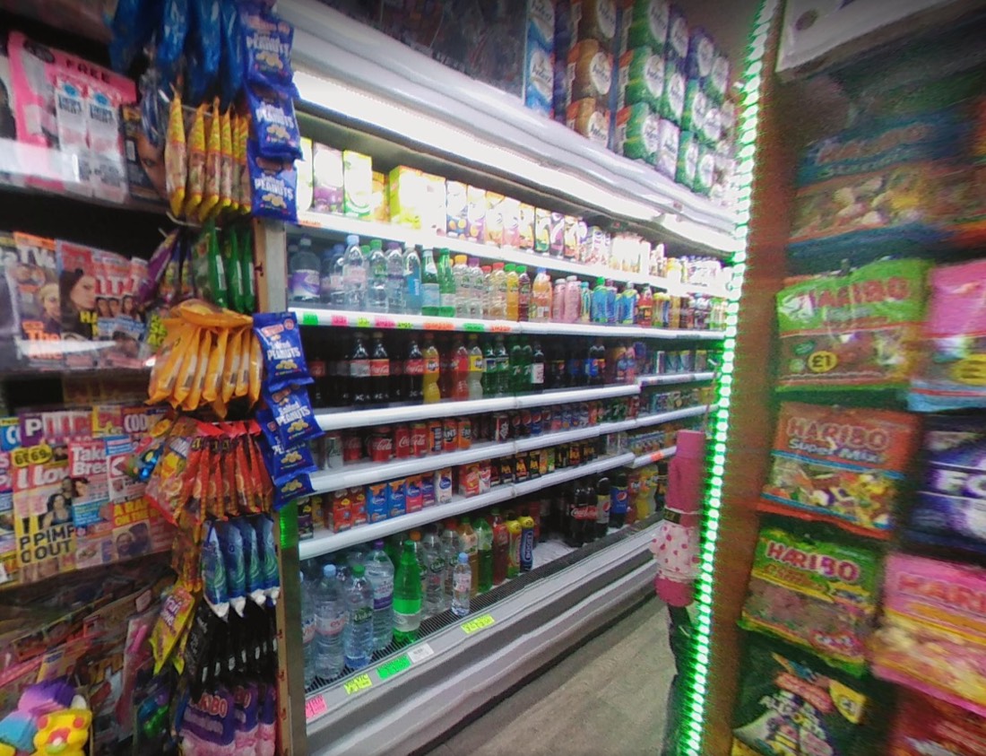 Inside Globe Food and Wine: a well-stocked chiller of soft drinks and water, with snacks, sweets and magazines alongside.